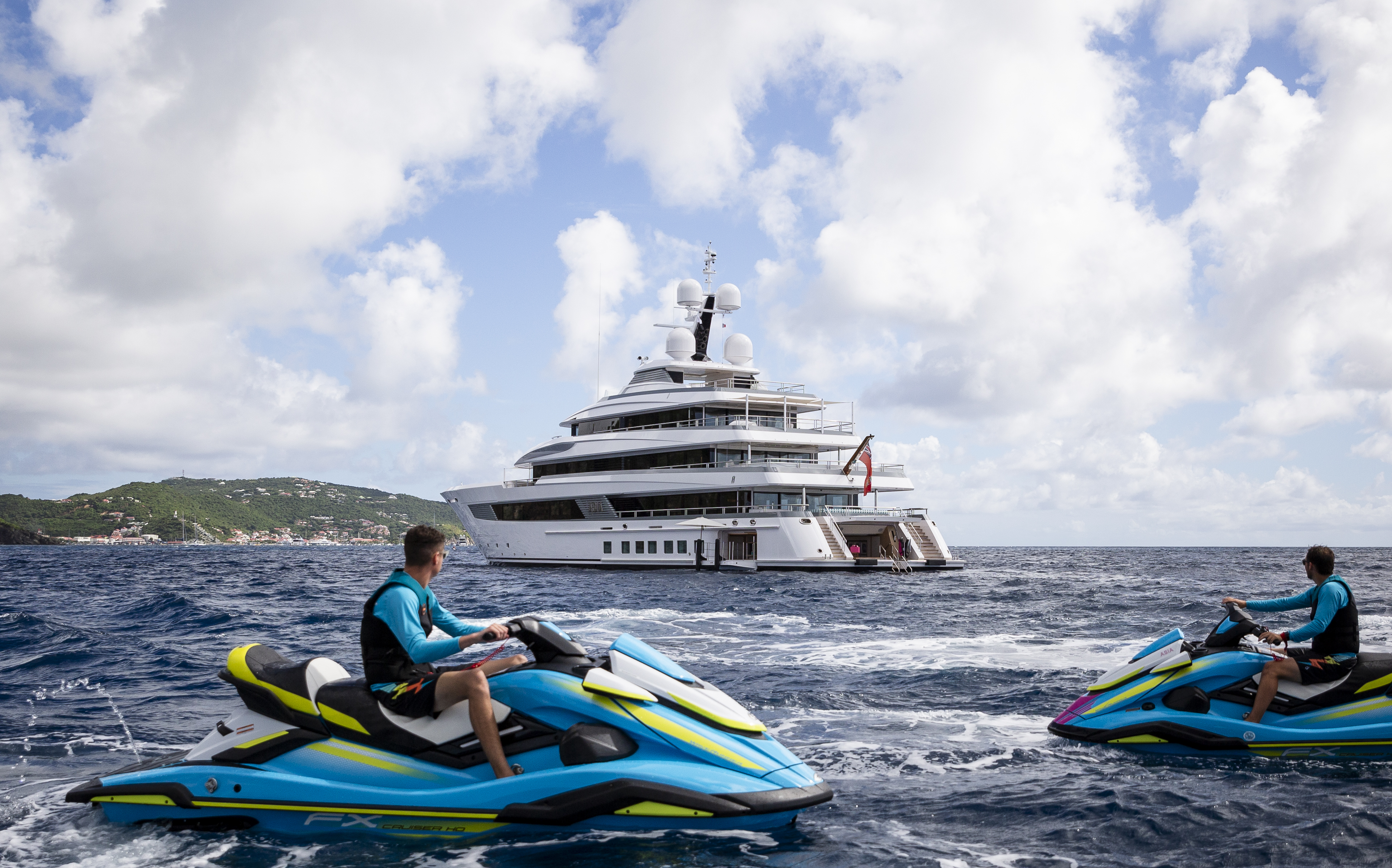 People on Jet Skis Looking at a Yacht